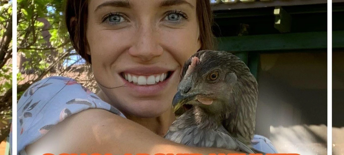 Ashley Reaves poses and smiles, holding a bird.