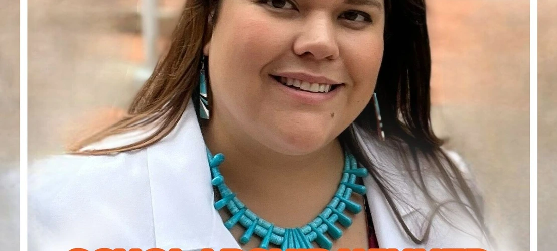 Nicole Kenote smiles and wears a turquoise necklace and doctor's coat.