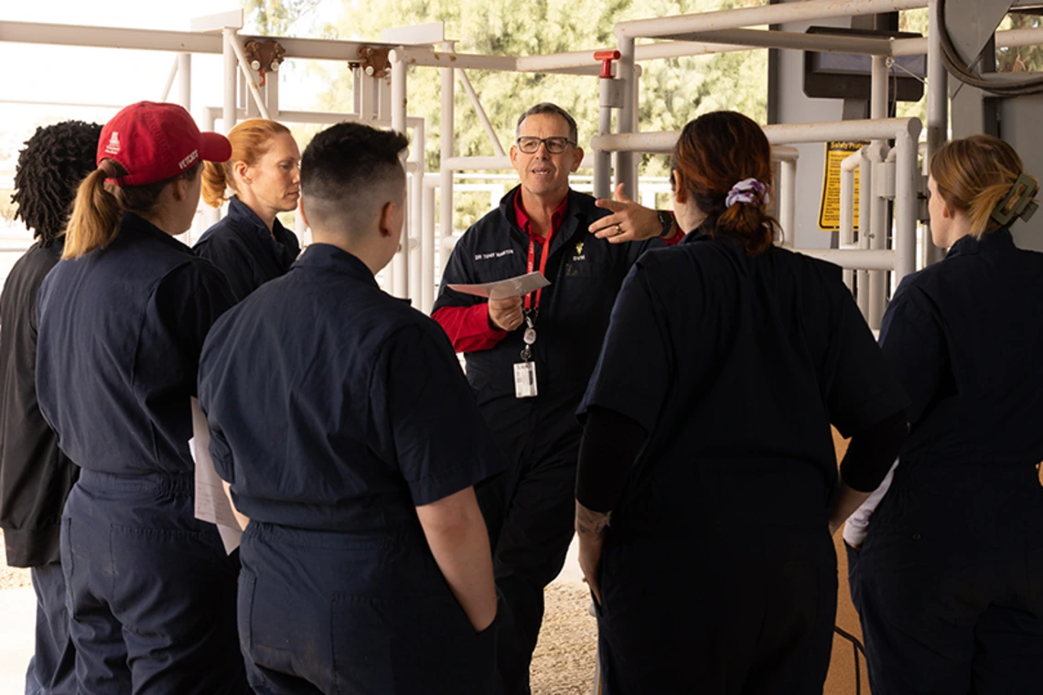 Instructor speaking to group of students