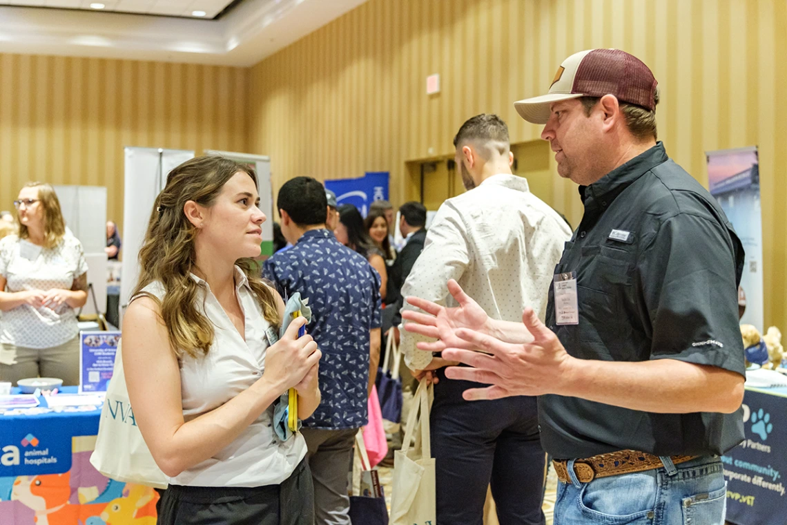 Student talking with practice owner at the career fair.