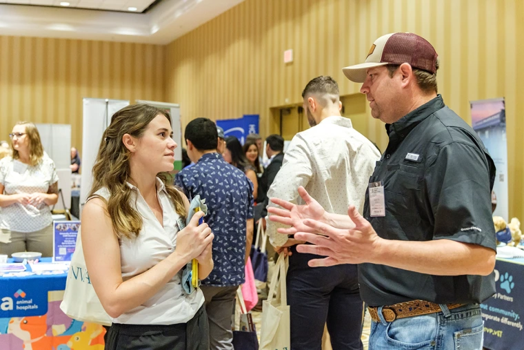 Student talking with practice owner at the career fair. 