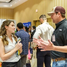Student talking with practice owner at the career fair. 